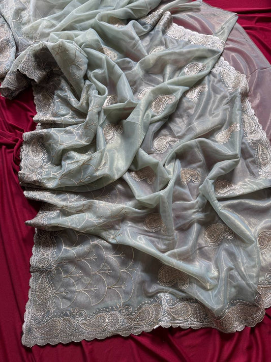 Pure zari tissue silk saree in a solid color with embroidery saree