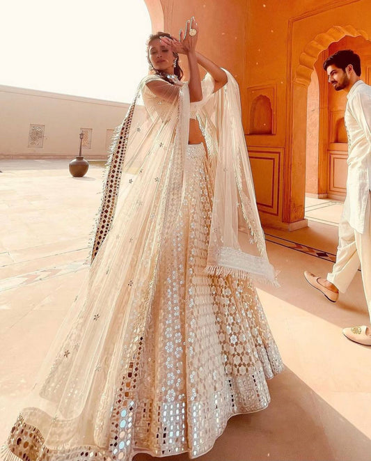 Look drop dead gorgeous in this beautiful off white lehenga set