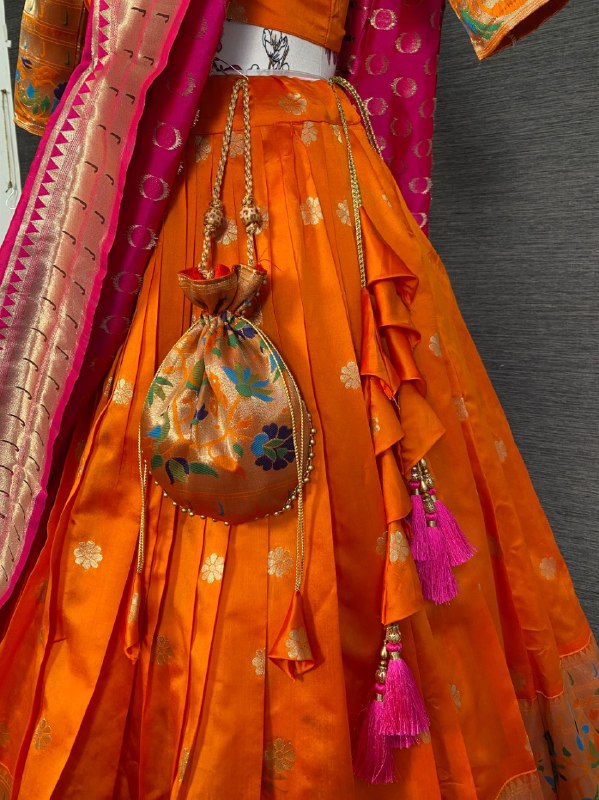 Get traditional touch to your look adorning this orange color lehenga