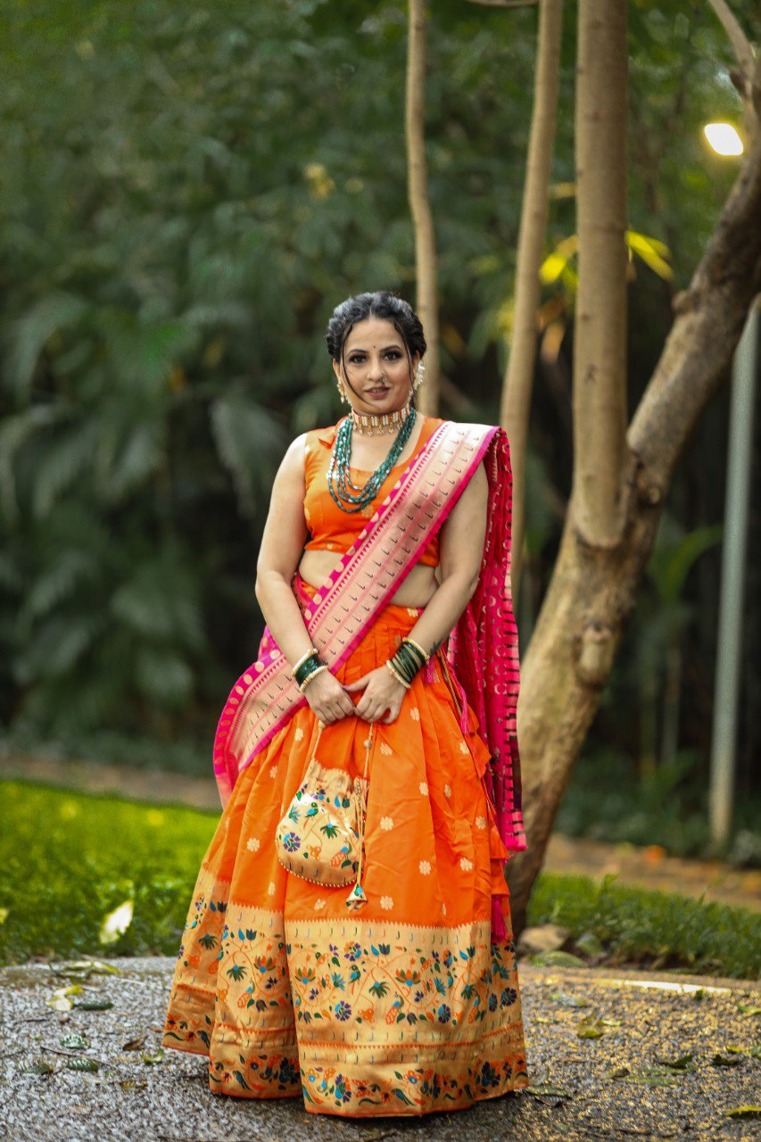 Get traditional touch to your look adorning this orange color lehenga