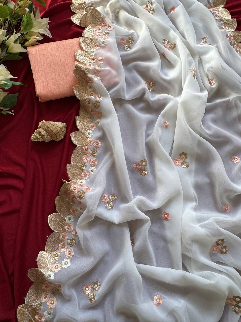 white chiffon georgett saree adorned with peach & gold floral embroidery saree